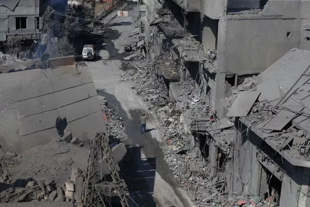 A man walks amid destroyed buildings in the town of Nabatiyeh, south Lebanon