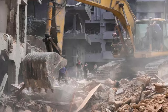 Rescue workers searching for victims at the site of an Israeli air strike in Beirut, Lebanon