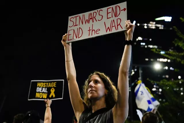 A demonstrator holds a sign during a protest in Tel Aviv