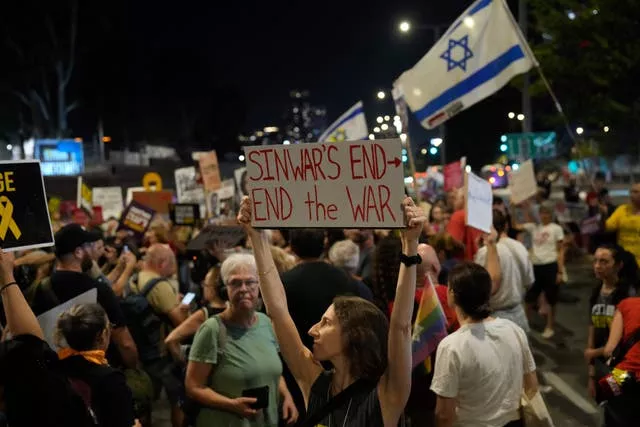 A demonstrator in Tel Aviv, Israel, holds a sign about the killing of Hamas leader Yahya Sinwar during a protest calling for a ceasefire deal and the immediate release of hostages held by Hamas