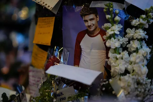 A picture of former One Direction singer Liam Payne adorns a memorial outside the hotel 