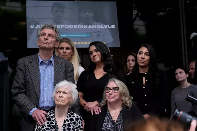 Family members sitting together during a press conference 