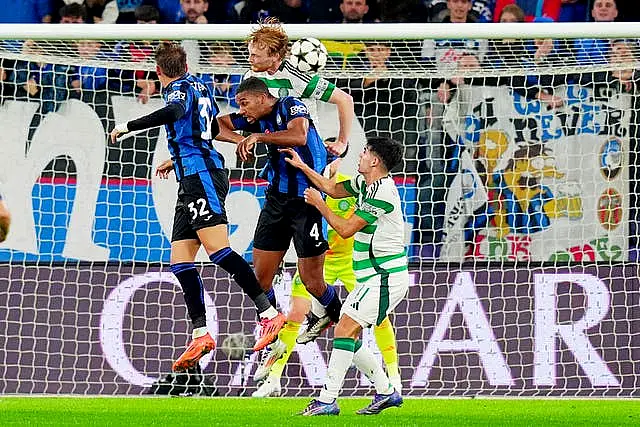 Isak Hien, centre, challenges for a header in the box