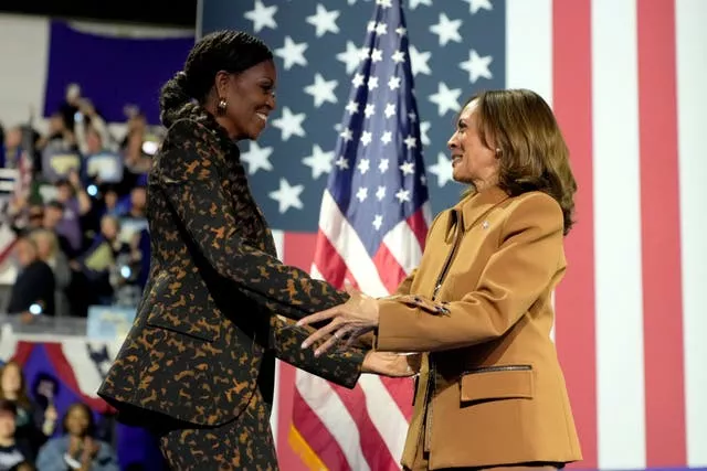 Michelle Obama shaking hands with Kamala Harris