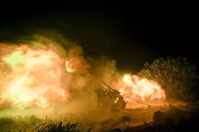 Ukrainian servicemen fire from a 122mm artillery cannon towards Russian positions in Kherson