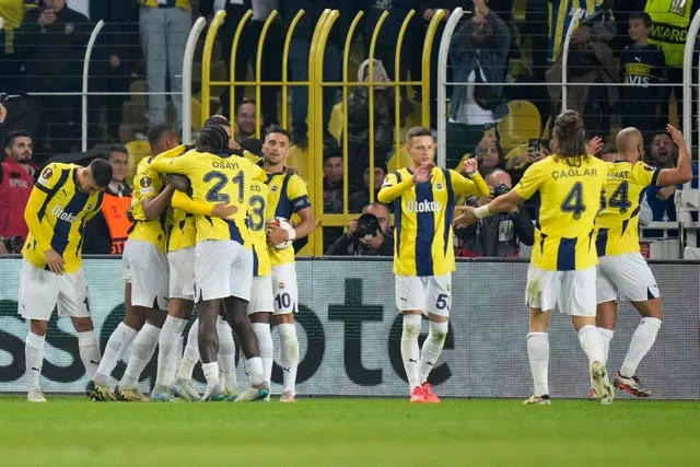 Fenerbahce players hug as they celebrate the equaliser