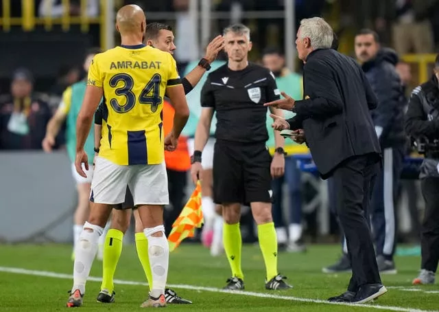 Fenerbahce head coach Jose Mourinho, right, argues with the referee as Sofyan Amrabat looks on