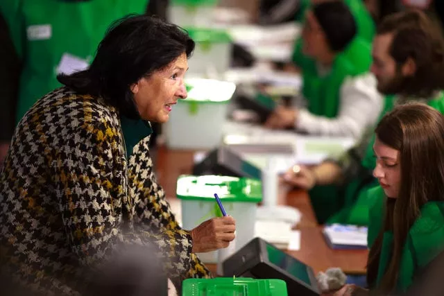 Georgian President Salome Zourabichvili gets her ballot at a polling station during the parliamentary election in Tbilisi, Georgia