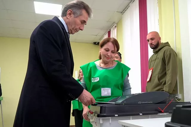 In this photo taken from video, Bidzina Ivanishvili, leader of the Georgian Dream party, votes at a polling station during the parliamentary election in Tbilisi, Georgia