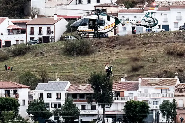 Emergency teams rescue a person who was stranded by the water in a Guardia Civil helicopter, after the floods preceded by heavy rains that caused the overflow of the river in the town of Alora, Malaga, Spain 