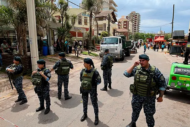 Police block a street leading to the Dubrovnik Hotel where firefighters and rescuers work to find survivors after the hotel collapsed, in Villa Gesell, Argentina