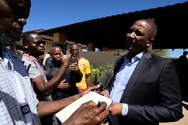 Umbrella for Democratic Change (UDC) presidential candidate Duma Boko speaks to journalist after casting his vote during the elections in Gaborone 