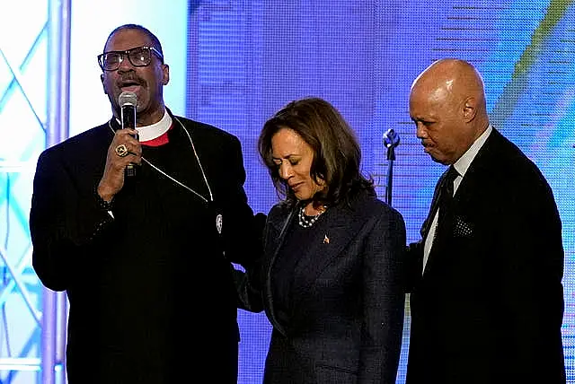 Bishops John Drew Sheard, left, and Michael Hill, right, with Kamala Harris