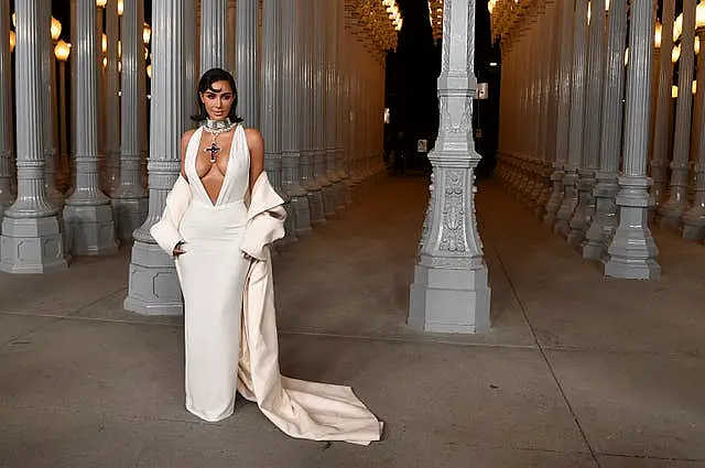 Kim Kardashian wears white Gucci dress and cross necklace at LA gala