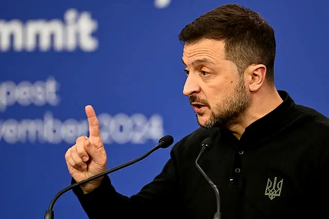 Volodymyr Zelensky gestures while speaking