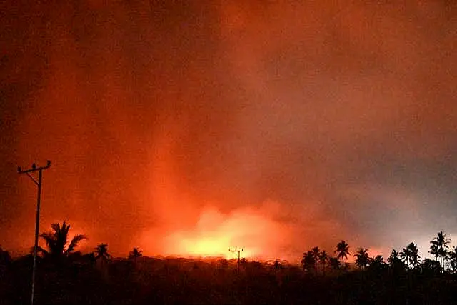 The sky glows from the eruption of Mount Lewotobi