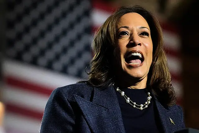 Kamala Harris gives a speech before the stars and stripes