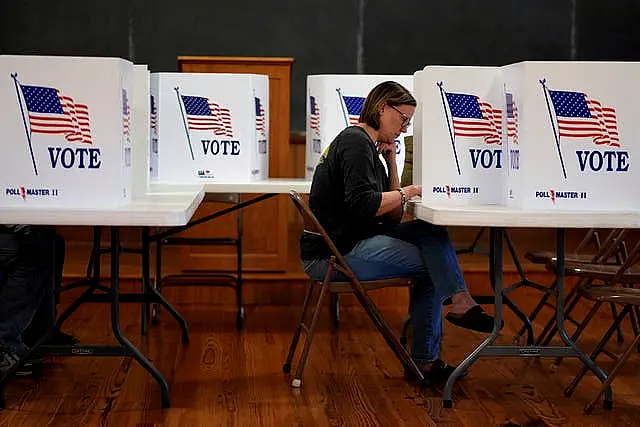 Kristin Scruggs votes at the 146-year-old Buck Creek School on Election Day in rural Perry, Kansas