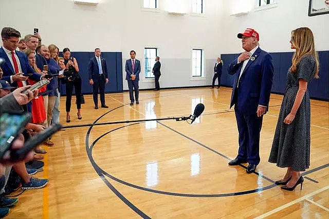 Republican presidential nominee Donald Trump speaks as former first lady Melania Trump listens after they voted on Election Day at the Morton and Barbara Mandel Recreation Centre in Palm Beach, Florida