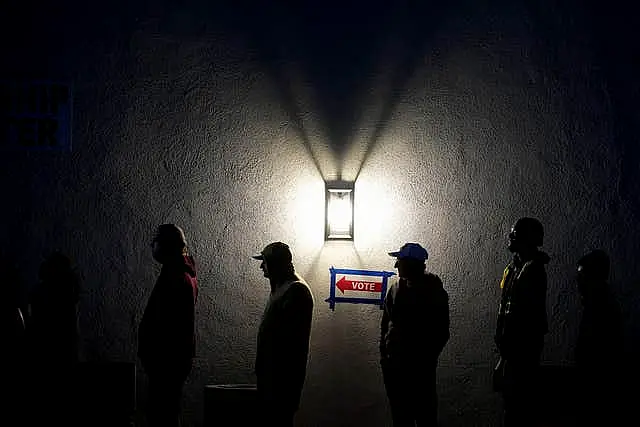 Voters stand in line outside a polling place at Madison Church in Phoenix, Arizona