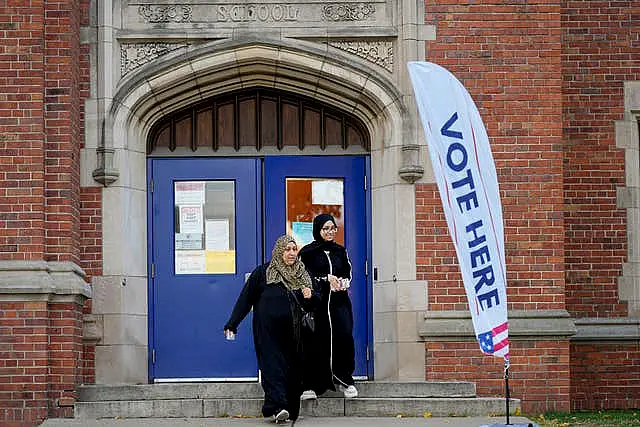 Voters depart a polling place at McDonald Elementary School in Dearborn, Michigan 