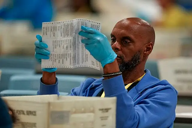 An election worker processing postal votes at the Philadelphia Election Warehouse