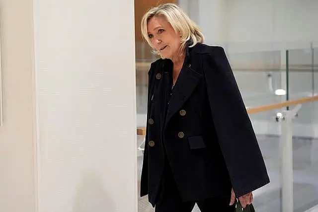 Marine Le Pen outside court in a black outfit