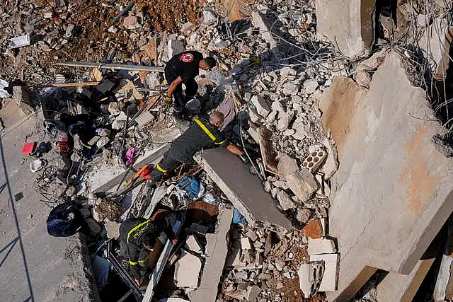 Rescuers search the rubble