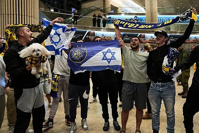 Maccabi Tel Aviv fans arrive at Israel’s Ben-Gurion International Airport (Tsafrir Abayov/AP)