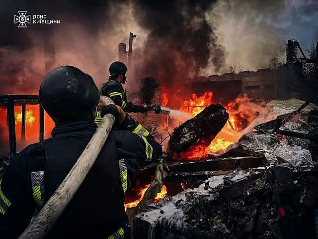 Rescue workers put out a fire at a building