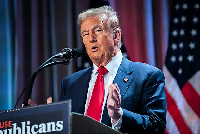 President-elect Donald Trump speaking with the America flag behind him