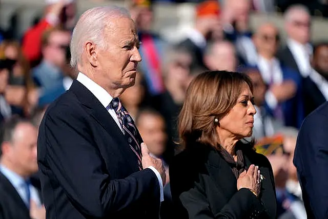 Joe Biden and Kamala Harris place their hands over their hearts