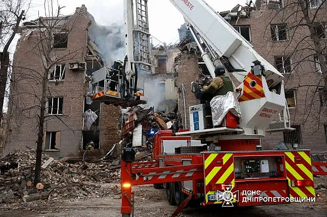 Firefighters work at the site of an apartment building destroyed by a Russian attack in Ukraine