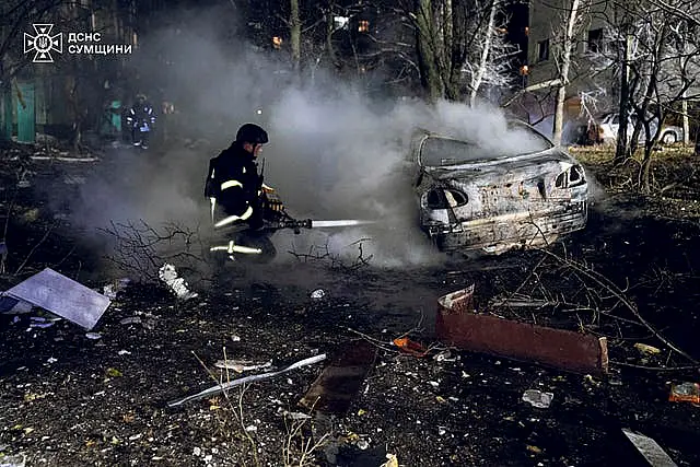 Firefighters extinguish a fire following a Russian rocket attack that hit a multi-storey apartment building in Sumy, Ukraine