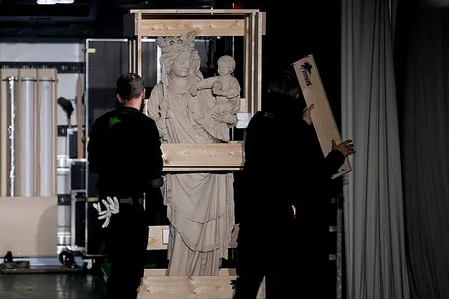 The original Virgin Mary statue, which did not suffer from the 2019 fire, is displayed before returning in the Notre-Dame cathedral outside the cathedral in Paris