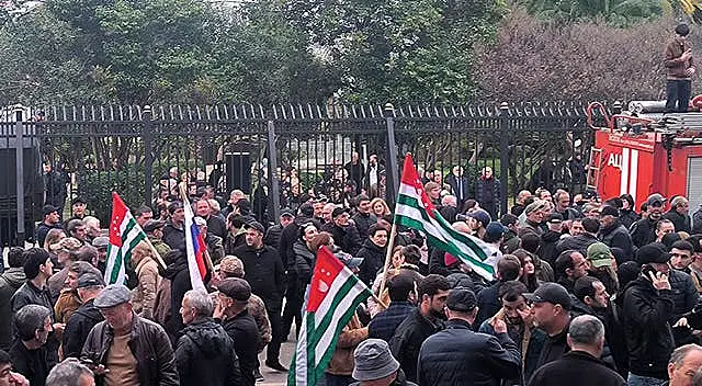 Protesters with Abkhazian flags gathered outside the parliament building of the Georgian separatist region of Abkhazia on Friday 