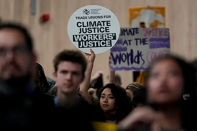 Activists with placards participate in a demonstration for climate justice