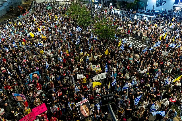 A crowd of people gather at a protest in Tel Aviv