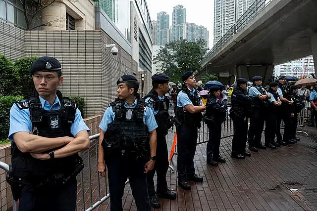 Police officers stand guard outside the court in Hong Kong 