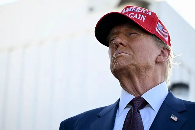 A close-up of Donald Trump in a red baseball cap