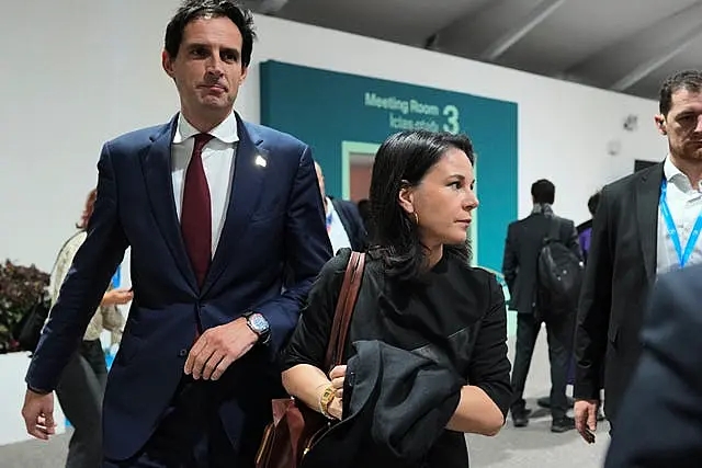 Wopke Hoekstra, EU climate commissioner, left, and Germany's foreign minister Annalena Baerbock walk through the Cop29 UN Climate Summit