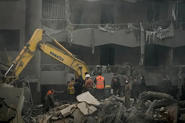 Rescue workers searching for victims at the site of the air strike in central Beirut