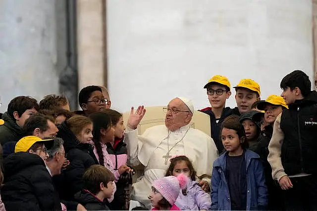 Pope Francis greets a group of children during his weekly general audience in St Peter’s Square at The Vatican 