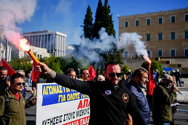 Striking workers in Greece let off flares