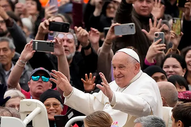 The Pope waves to the faithful