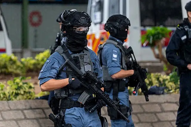 Armed police stand guard outside the West Kowloon Magistrates’ Courts