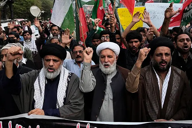 People chant slogans to condemn the killing of Shiite Muslims by gunmen in an ambush in Kurram district, during a demonstration in Lahore, Pakistan, on Friday