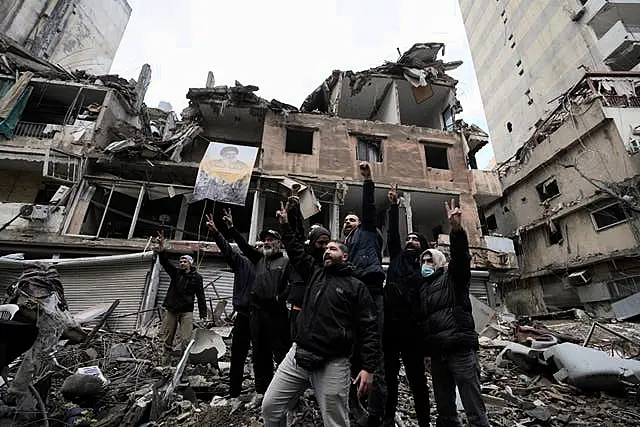 Hezbollah supporters cheer as they return to Dahiyeh, in Beirut