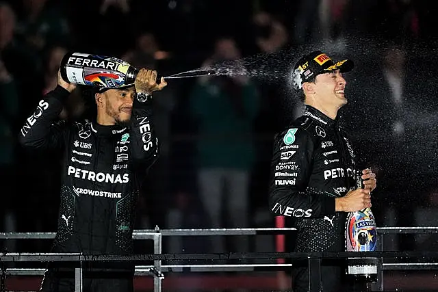 Lewis Hamilton sprays champagne on team-mate George Russell on the Las Vegas Grand Prix podium