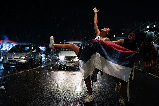 Supporters of the Frente Amplio (Broad Front) celebrate the victory of candidate Yamandú Orsi 